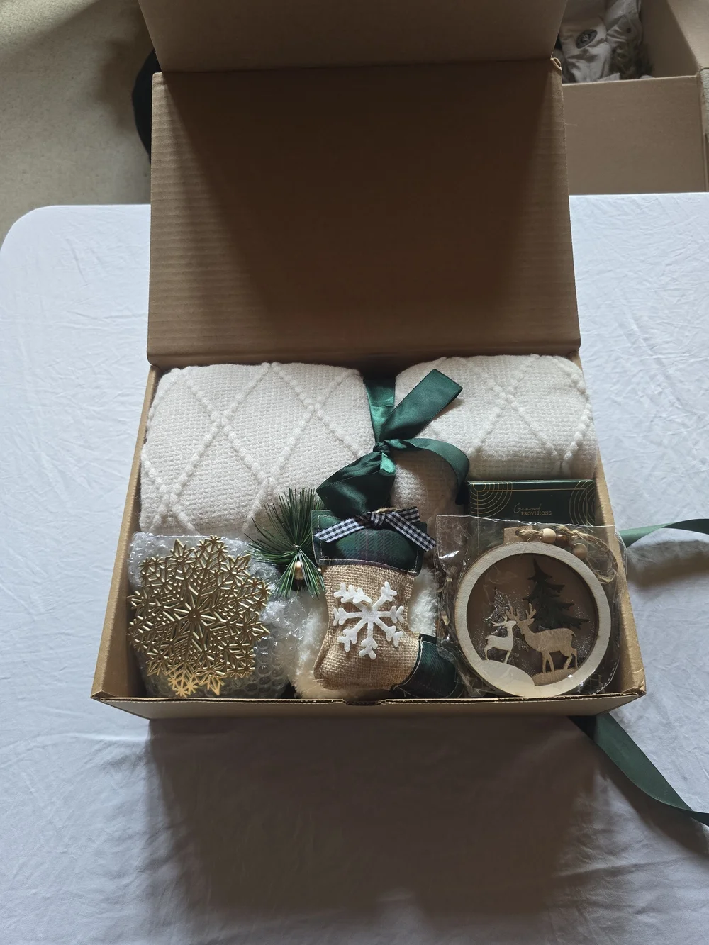 Holiday Home Gift Box with Cream Knit Throw and Green Ribbon Accents